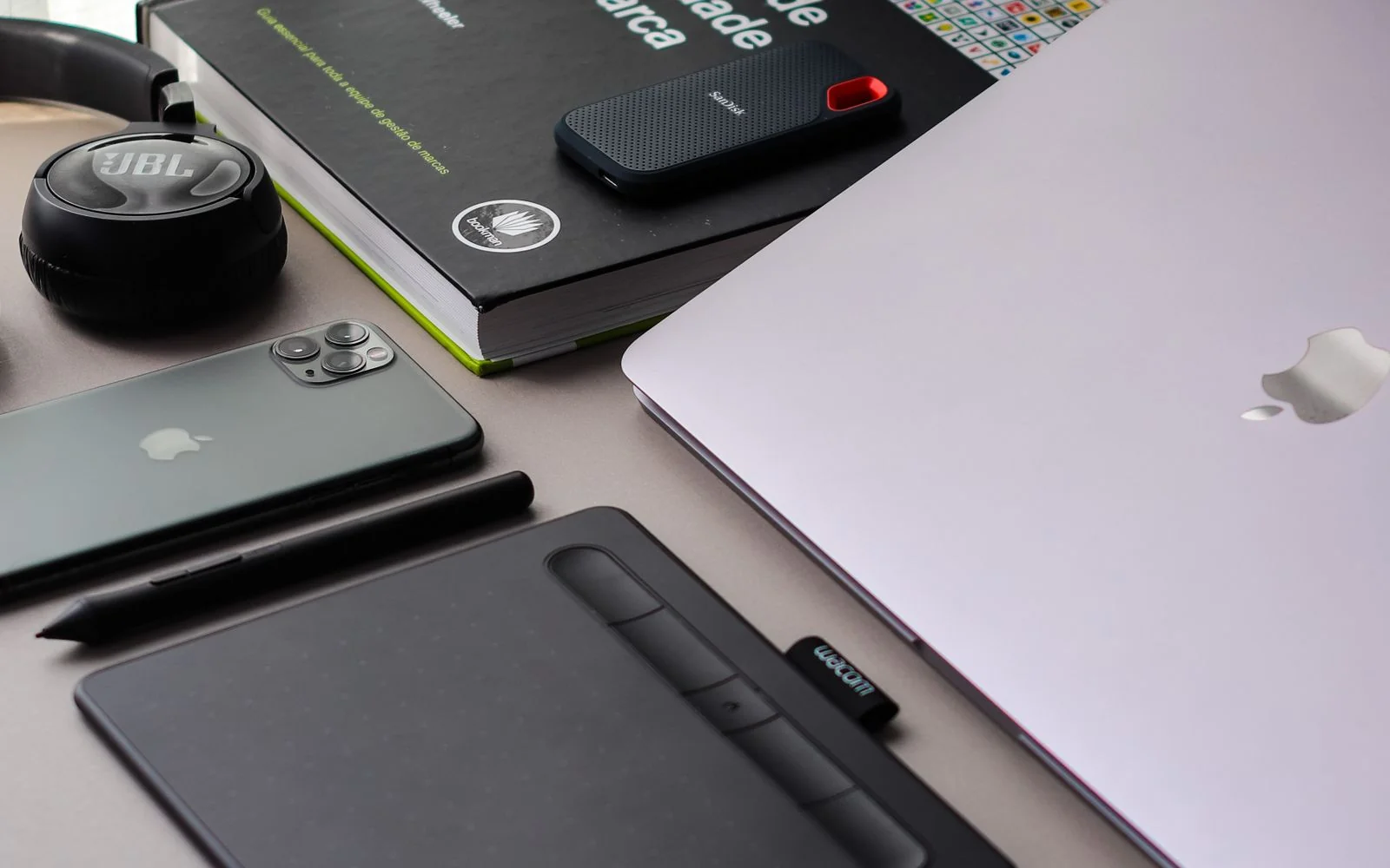 A desk with a tablet and a laptop side by side