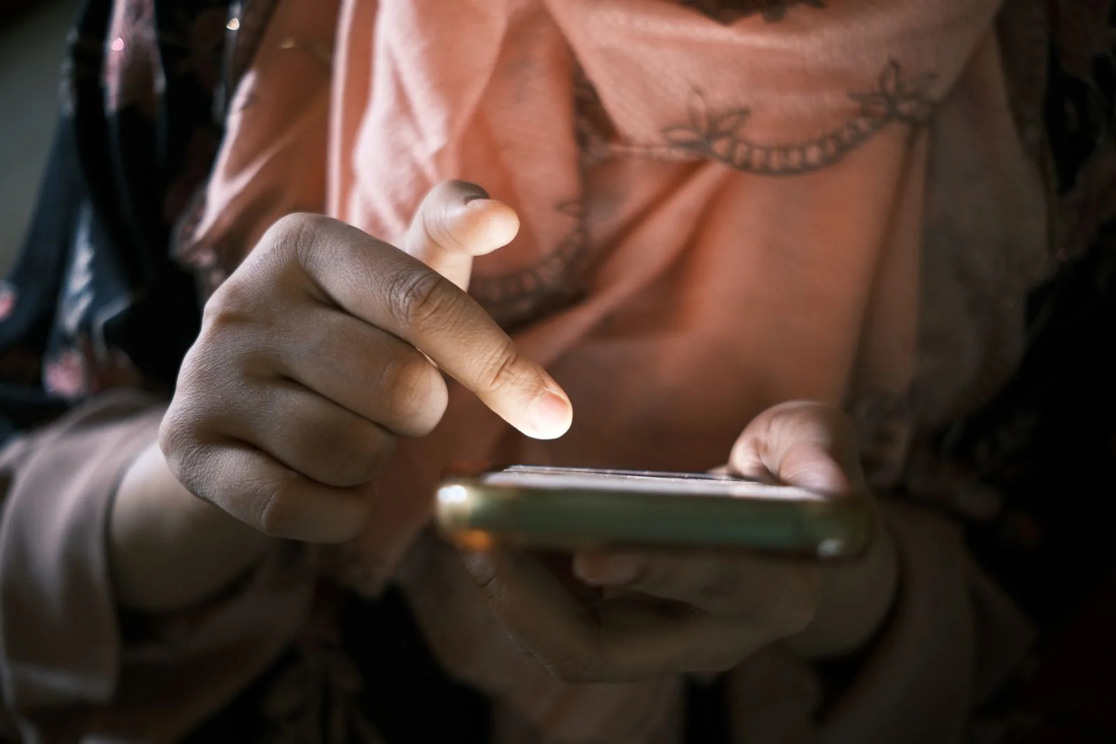 Close-up of hands using a smartphone touchscreen