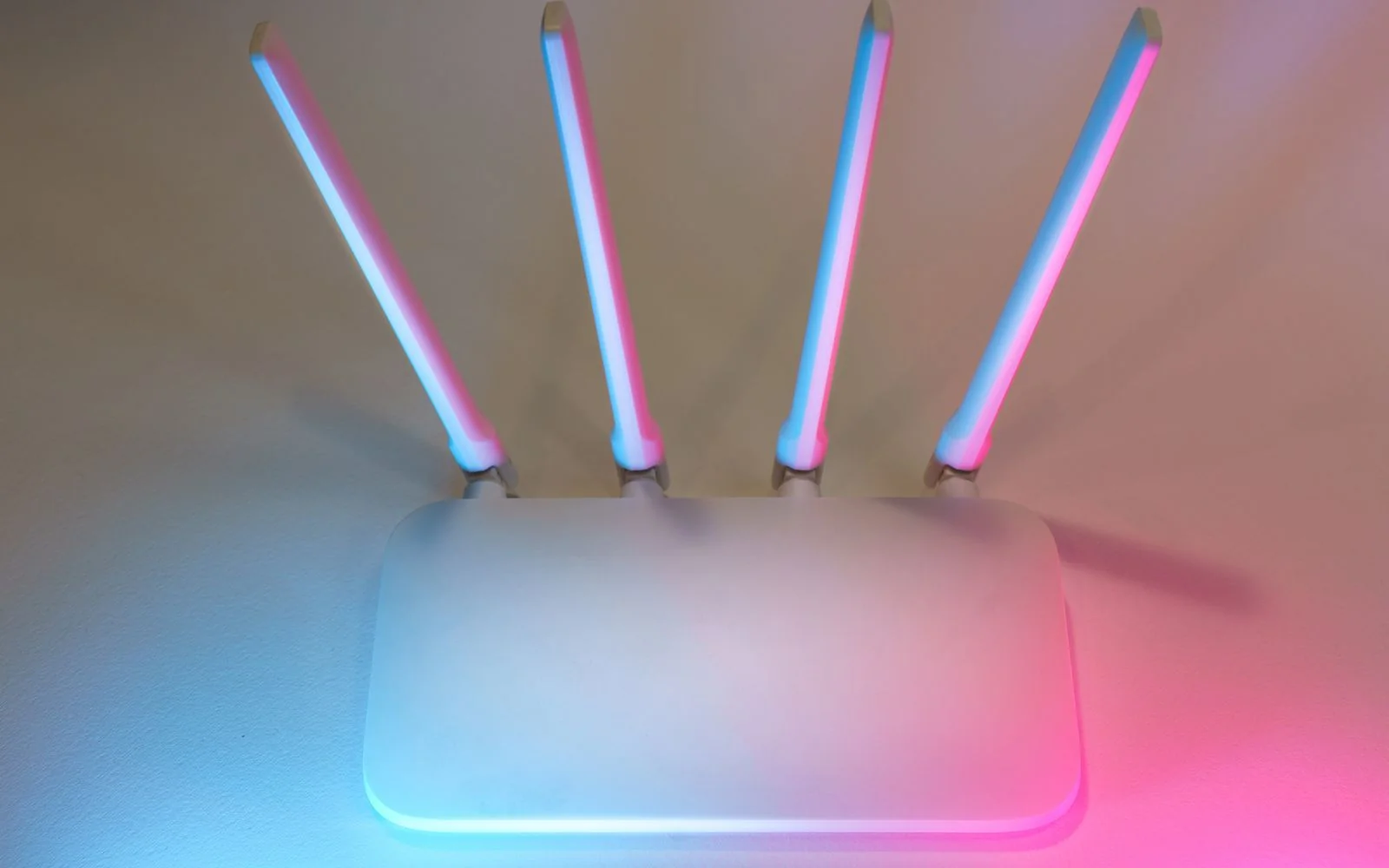 A white wireless router with four antennas